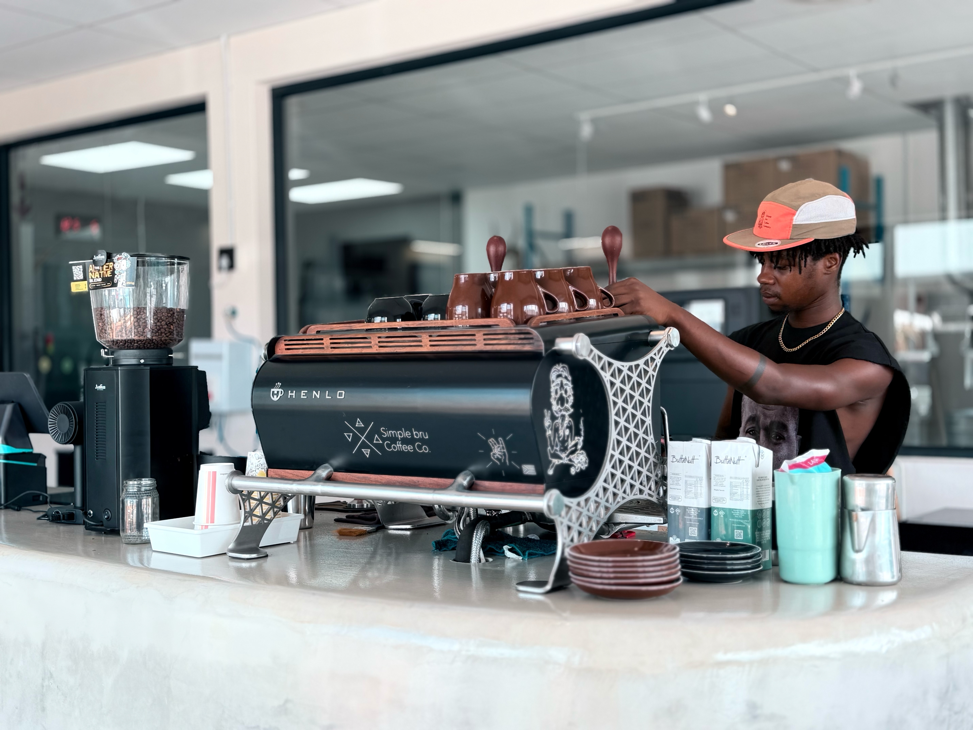 Barista carefully pouring latte art at Simple Bru Coffee